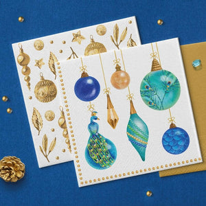 PAW Paper Napkins Peacock Collection design arranged on a blue background with gold accents.