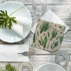 PAW We Care Herbal Pickings Paper Napkins styled on a wooden table with white plates and herbs.