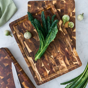 Peer Sorensen End Grain Cutting Board with Juice Groove styled with green vegetables on a light surface