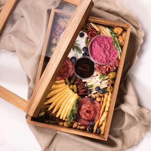 Peer Sorensen Acacia Grazing Box filled with charcuterie, cheeses, and crackers