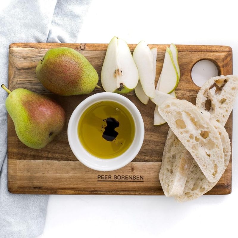 Medium sized Peer Sorensen Long Grain Cutting Board styled with pears, bread, and olive oil