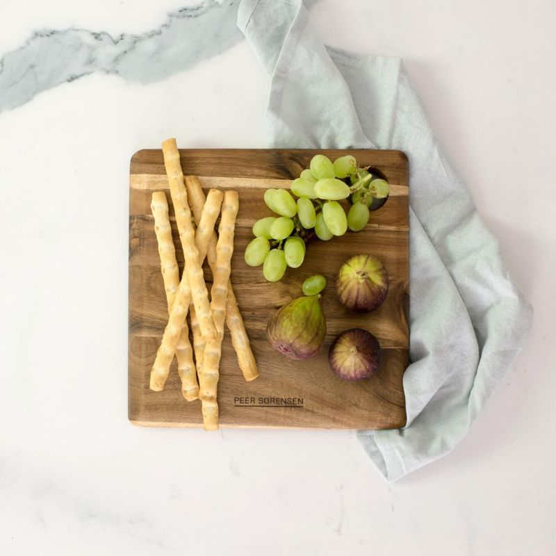 Small Peer Sorensen Long Grain Cutting Board styled with breadsticks, grapes, and figs