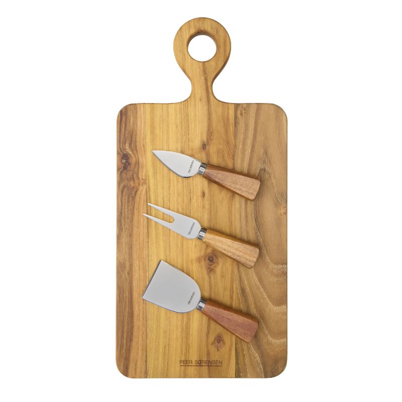 Teak paddle serving board with three stainless steel cheese accessories displayed on top.