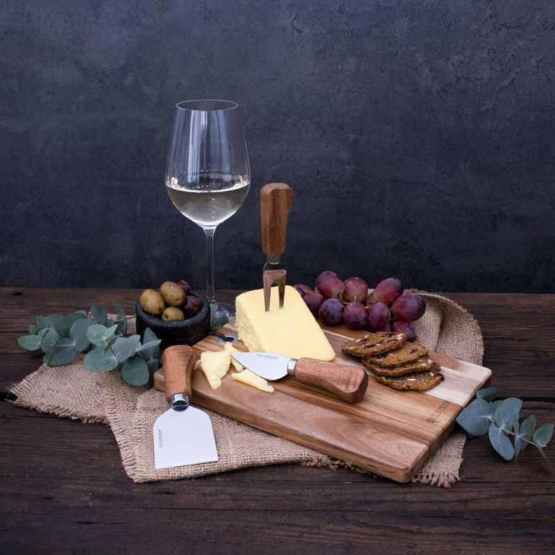 Peer Sorensen rectangular acacia cheese and serving board with three stainless steel cheese knives.