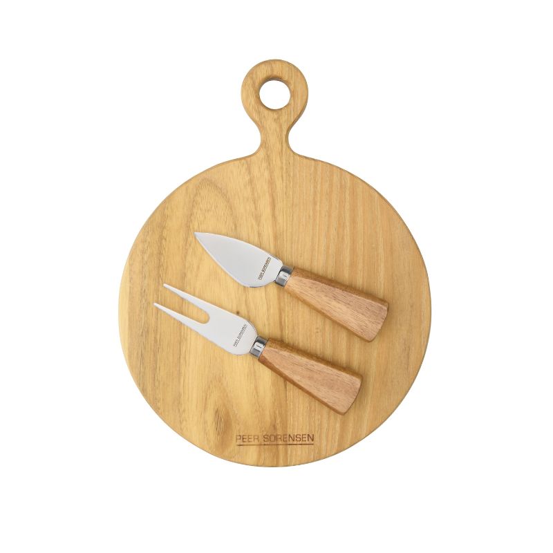 Small round teak paddle serving board with two stainless steel cheese knives featuring wooden handles arranged on top.