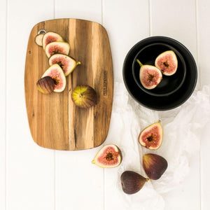 Peer Sorensen Slim Line Rounded Cutting Board with sliced figs on a white surface