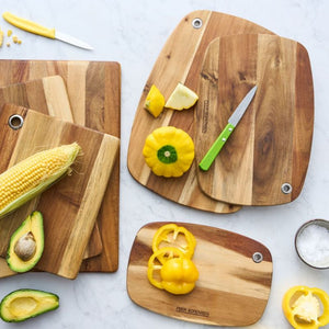 Peer Sorensen Slim Line Rounded Cutting Boards with vegetables and fruit on a marble table.