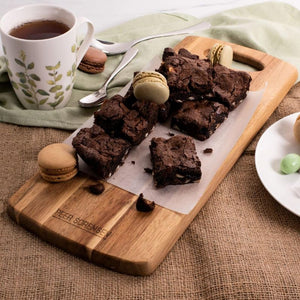 Peer Sorensen Tapas Serving Board holding brownies and macarons beside a teacup.