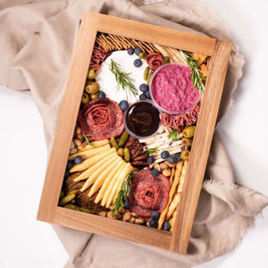Top view of Peer Sorensen Grazing Box filled with cheese, meats, dips, pickles and fruits - shown with lid on.