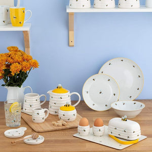 Price & Kensington Sweet Bee collection shown on a wooden table with a blue background.