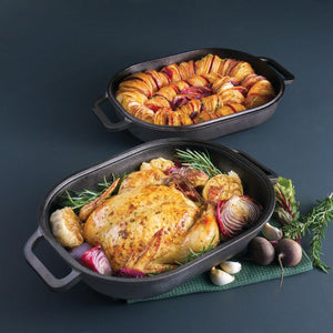 Pyrolux Pyrocast Bake & Roast Set styled with a whole chicken and vegetables on a dark background