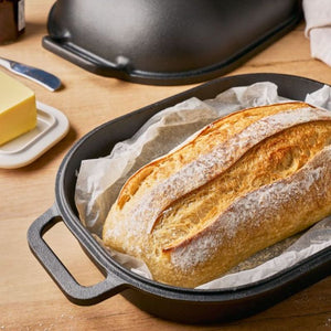 Loaf of bread in the Pyrolux Pyrocast Bake & Roast Set on a wooden table.