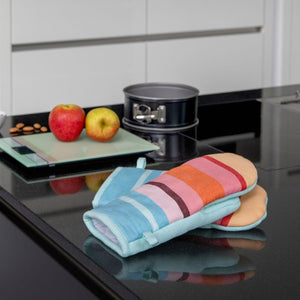Remember Oven Mitts No. 4 on a kitchen bench top with apples, scales and a cake tin in the background - NZ kitchen