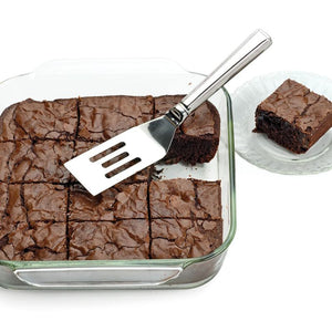 RSVP Stainless Steel Brownie Spatula next to a pan of cut brownies.