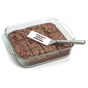 RSVP Stainless Steel Brownie Spatula styled over a pan of cooked brownie.