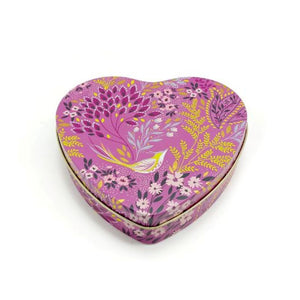 Sara Miller Mauve Songbird Small Heart Tin featuring a vibrant floral and bird pattern in shades of pink, purple, yellow, and white, set against a plain white background.
