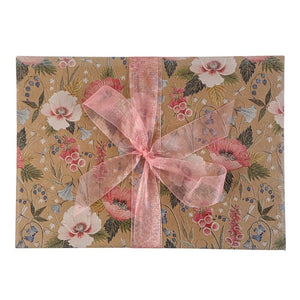 Floral-patterned kraft paper with pink ribbon