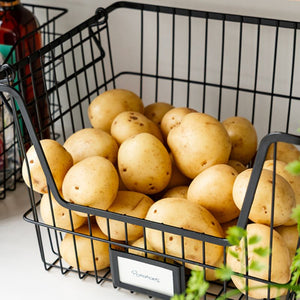 Black wire stacking basket with potatoes inside, pantry storage solution