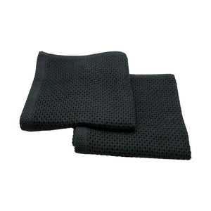 Two black Simple Things cotton wash cloths laid flat on a white background.