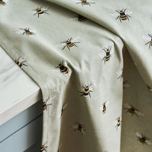 Close up of the bee motif and fabric of the Sophie Allport Bees Tea Towel.