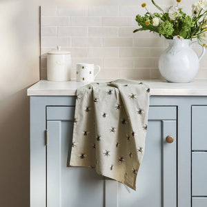 Sophie Allport Bees Cotton Tea Towel shown draped over a kitchen benchtop.