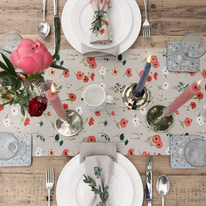 Sophie Allport Poppy Meadow table runner and napkins on a rustic farmhouse table.