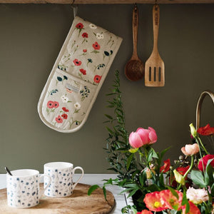 The Sophie Allport double oven mitt in the Poppy Meadow design hanging in a farmhouse kitchen.
