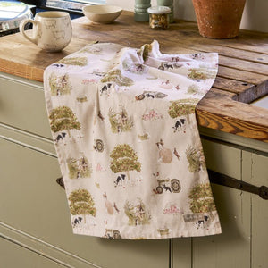 Sophie Allport Farm Friends Tea Towel  shown draped across a wooden benchtop.