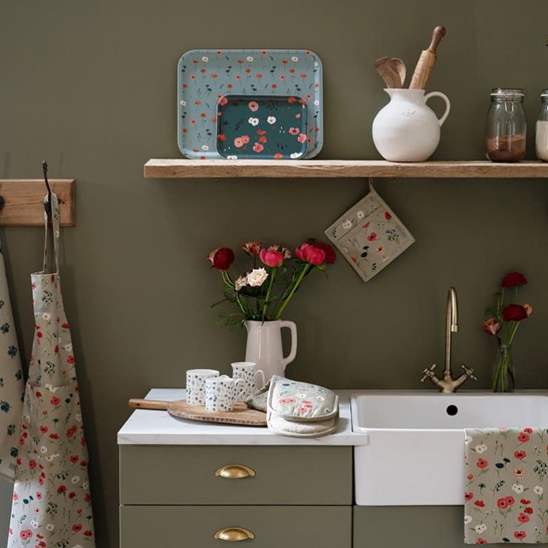 Sophie Allport Poppy Meadow apron, pot grab, double oven mitt, and tea towel in a rustic farmhouse kitchen - NZ