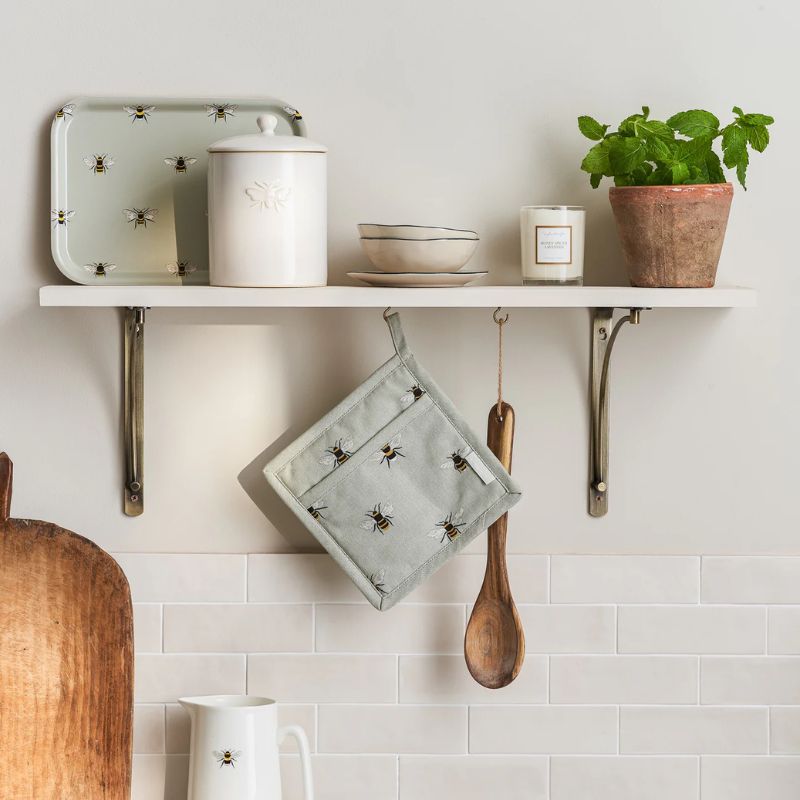 Sophie Allport Bees pot grab hanging on a kitchen shelf with matching accessories – pale green-grey with bee print – NZ