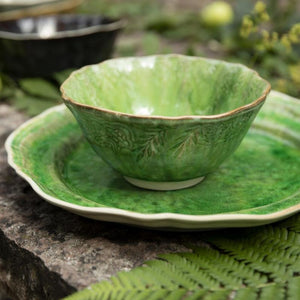 Seaweed green Sthal Arabesque breakfast / soup bowl on plate in garden setting.