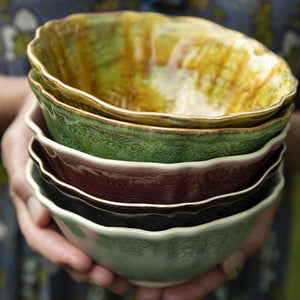 Hands holding a stack of Sthal Arabesque breakfast / soup ceramic bowls.