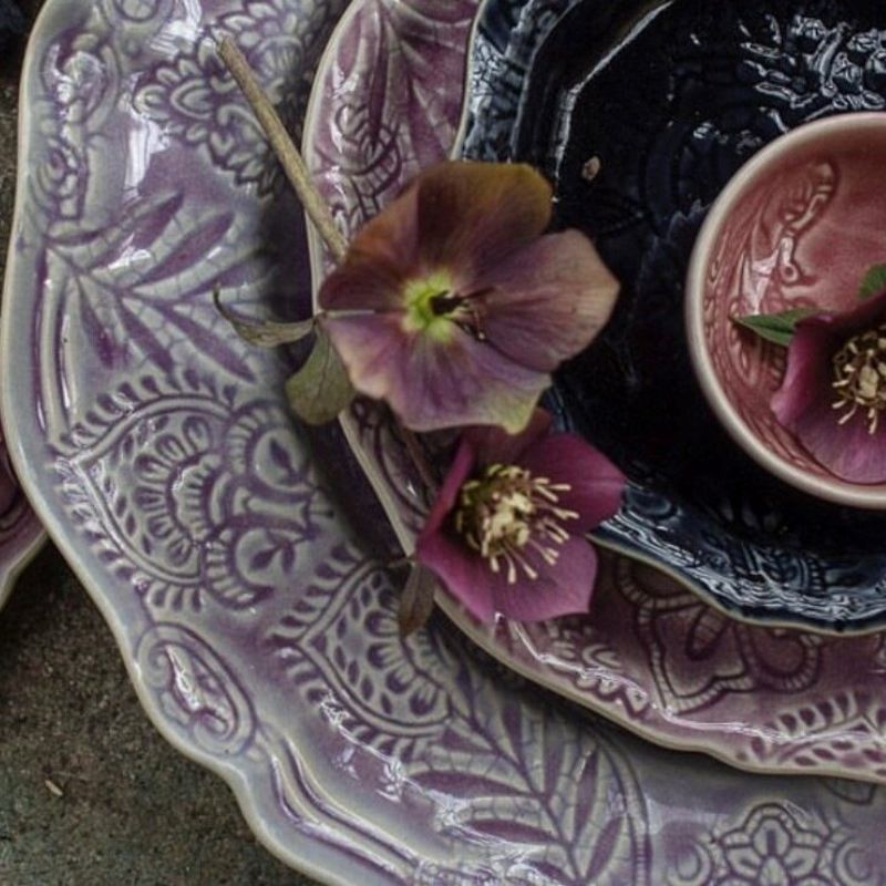 A stack of Sthal Arabesque plates and bowls in Lavender, Fig, and Old Rose colours.