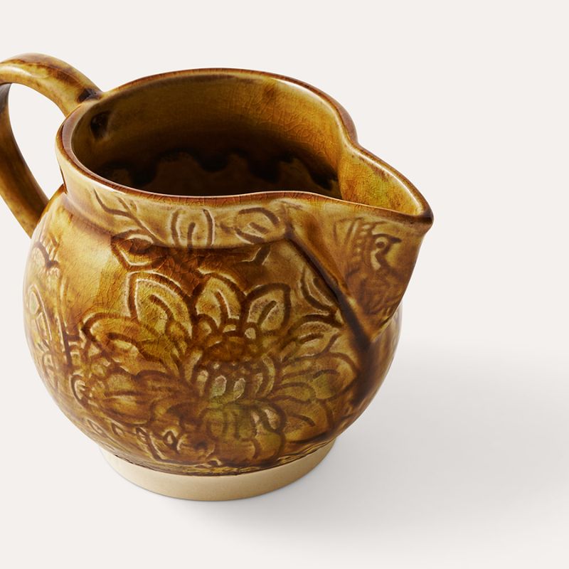 Sthal Arabesque Creamer in Pineapple colourway – a mustard yellow milk jug with intricate floral detail and a reactive glaze shown on a white background.