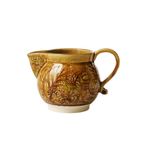 Sthal Arabesque Creamer in Pineapple colourway – a mustard yellow milk jug with intricate floral detail and a reactive glaze shown on a white background.
