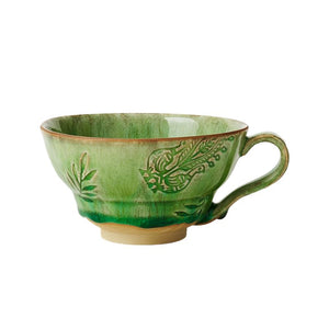 Sthal Arabesque Cup with Handle in the seaweed green colourway, shown against a green background.