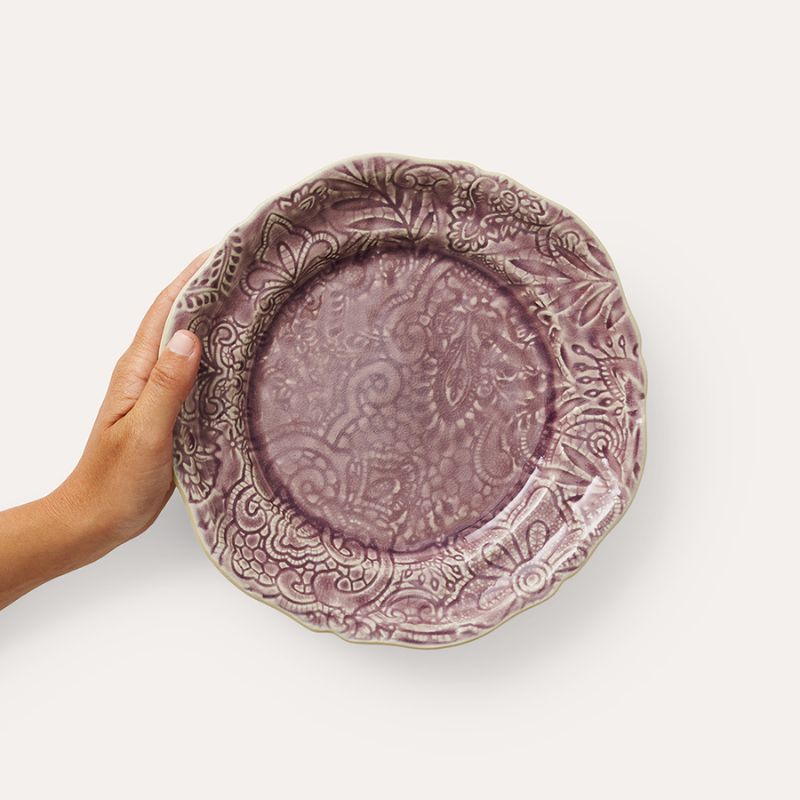 Hand holding Sthal Arabesque 23 cm Lavender plate showing scalloped edge and detail.