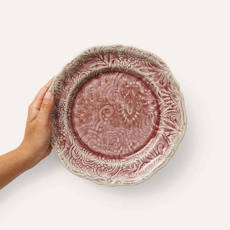 Hand holding Sthal Arabesque 23 cm Old Rose plate showing scalloped edge and detail.