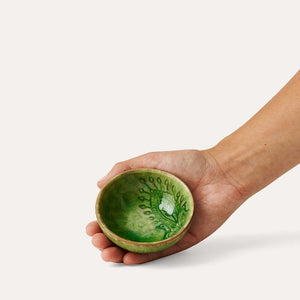 Hand holding Sthal Arabesque Seaweed dip bowl showing interior pattern.