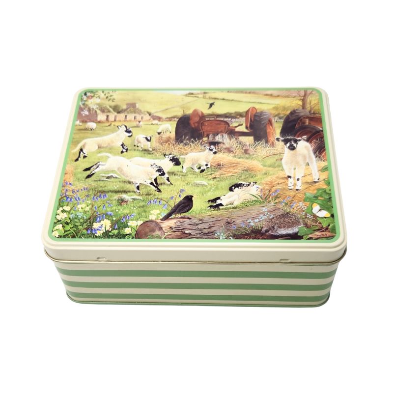 The Tracy Hall Woolly Jumpers Biscuit Tin with lambs and tractors on the lid and green stripes on the sides