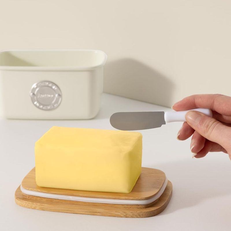 Typhoon Living Butter Dish in Cream shown front on against a white background.