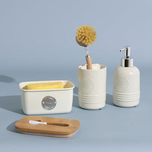 Typhoon Living Butter Dish in Cream shown against a blue background styled next to coordinating typhoon living products.
