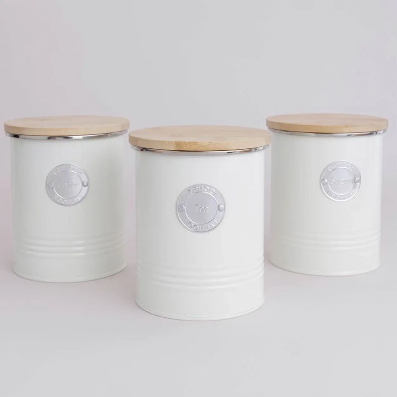 Cream tea, coffee, and sugar canisters with bamboo lids on a light background.