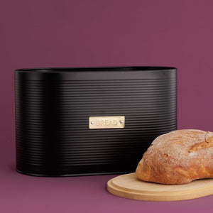 Typhoon Otto Bread Bin in Black styled with a loaf of bread on the bamboo lid