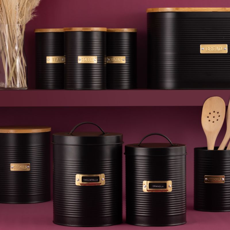 Typhoon Otto black storage canister range shown in a pink kitchen scene