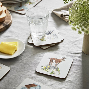 Ulster Weavers Portman Farm Coasters on a table with a glass of water and bread.