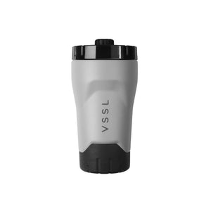 VSSL Rift Tumbler - Stone with a light gray body, black lid, and black textured base, shown on a plain white background.
