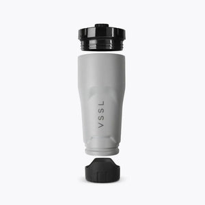 VSSL Rift Tumbler - Stone, shown disassembled with the black lid and base removed to showcase the design, on a white background.