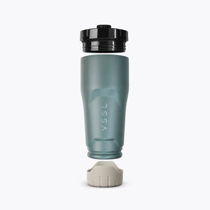 VSSL Rift Tumbler in Wild Sage, with a black screw-on lid, and a light grey base, shown against a plain white background.