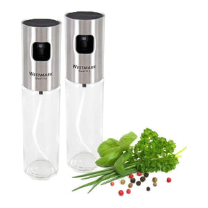 Westmark Oil & Vinegar Spray Set showing two stainless steel oil and vinegar spray bottles with herbs and peppercorns